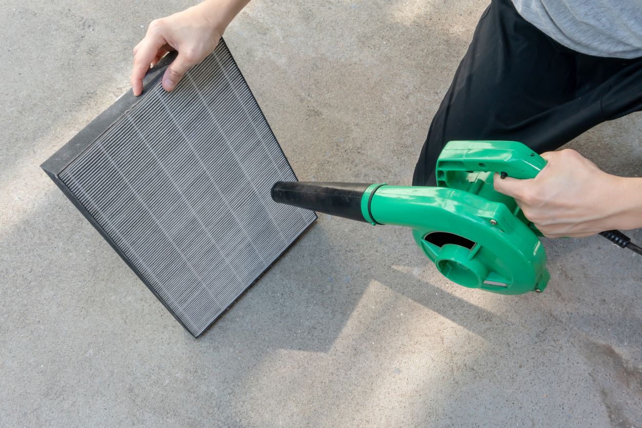 Homeowner cleaning reusable HVAC air filter