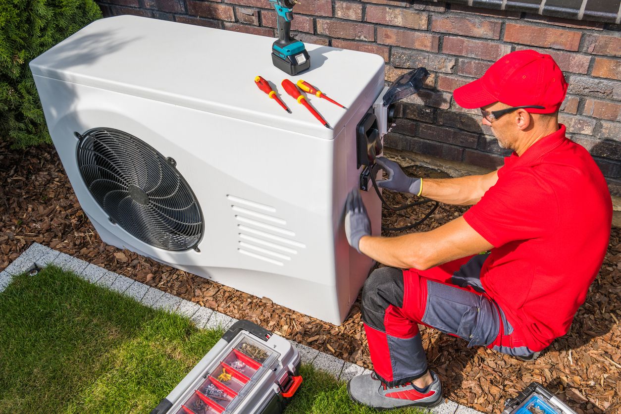 HVAC technician repairing heat pump